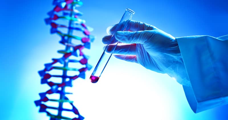 Hand Holding a Chemical Solution Test-tube in a bio-Chemistry DNA Research Laboratory